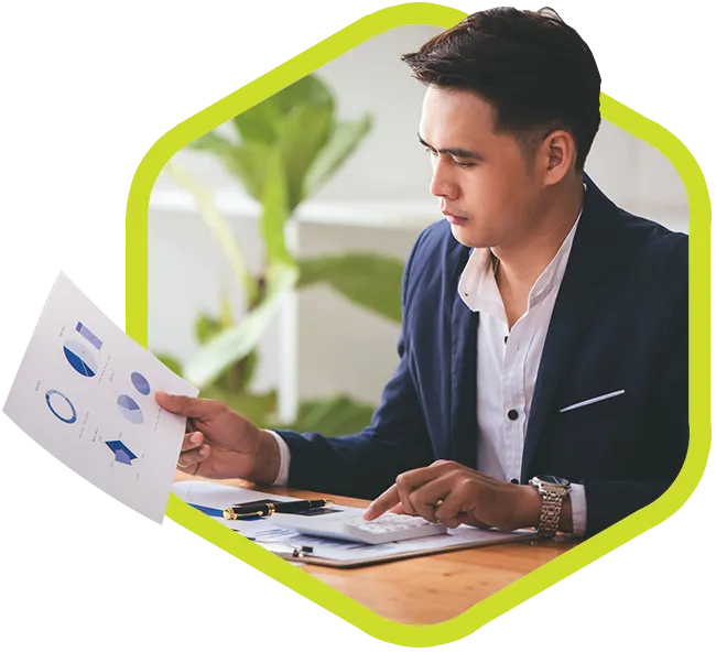 Young Asian executive reviews workplace productivity charts.